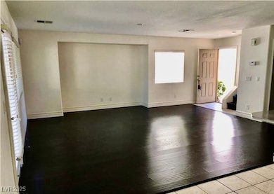 Entrance foyer featuring baseboards and wood finis