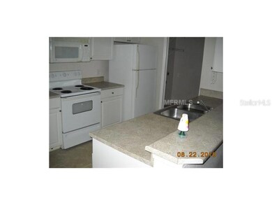 Kitchen - Plenty of room in the kitchen with eat-at-bar space, indoor laundry/storage room just off kitchen with washer/dryer hook-ups..