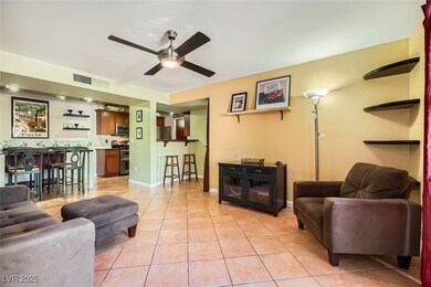 Living room featuring ceiling fan and light tile p