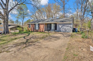 View of front facade with concrete driveway and fe
