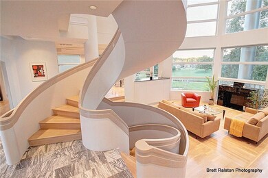 Dramatic floating staircase entry to living area w