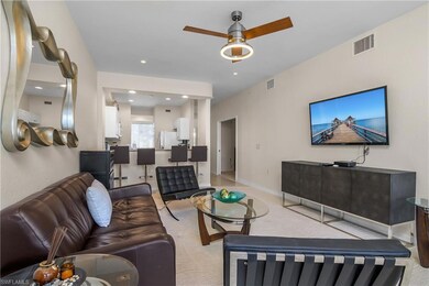 Carpeted living room featuring ceiling fan