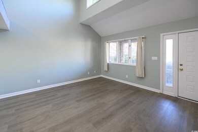 Foyer entrance with dark hardwood / wood-style flo
