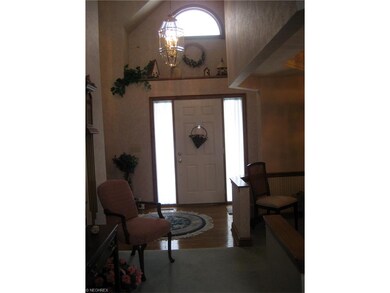 Inviting foyer with wood floors leads to formal di