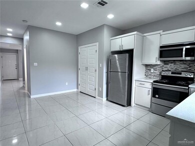 Kitchen featuring white cabinetry, tasteful backsplash, appliances with stainless steel finishes, baseboards, and visible vents