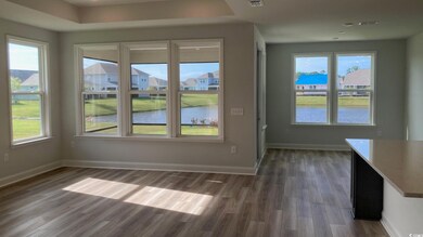 Gathering room & dining area with a water view and