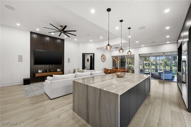 Kitchen with ceiling fan, light stone counters, ha