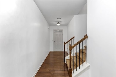 Corridor with wood finished floors and stairs