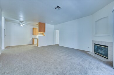 Unfurnished living room featuring ceiling fan, a f