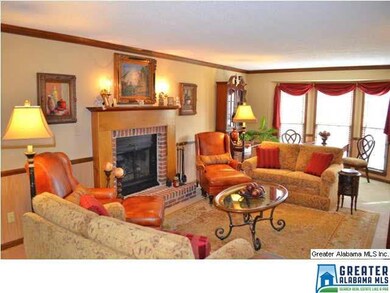 SPACIOUS GREAT ROOM W/NEUTRAL DECOR, FIREPLACE, WAINSCOTING,CROWN MOULDING AND A LOT OF NATURAL LIGHT ADORNS THE SPACE