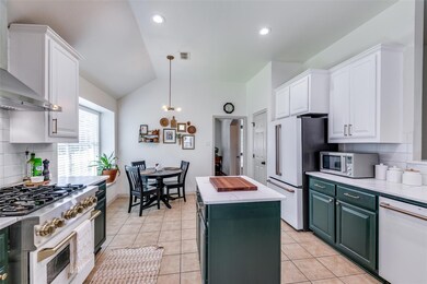 Kitchen featuring a center island, white cabinets,