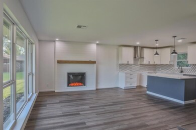 Kitchen featuring tasteful backsplash, pendant lig