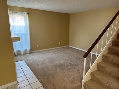 Tiled spare room featuring a textured ceiling