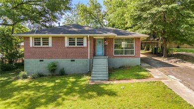 View of front of house with crawl space and brick 