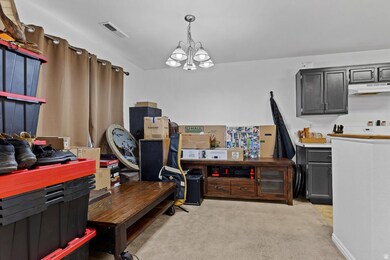 Office space featuring light carpet and a chandelier
