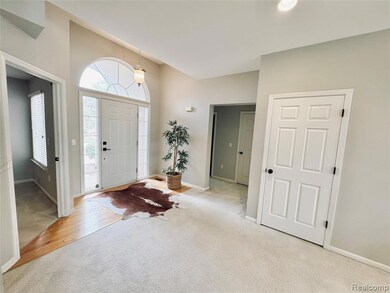 Entryway with carpet flooring and baseboards