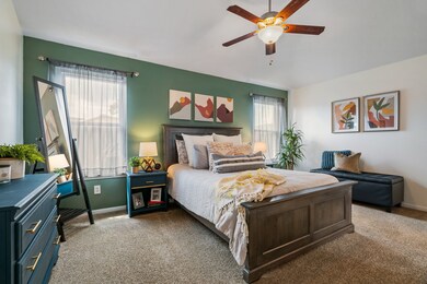 Roomy primary bedroom with lovely windows overlooking the backyard.