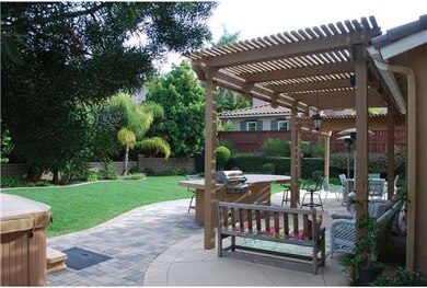 Nice lushly landscaped and private yard, perfect for entertaining with ample room for a large gathering, a built in BBQ and large island, covered patio and pavers.