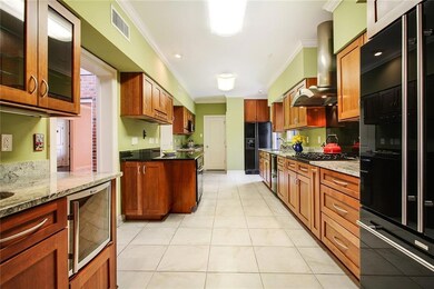 The large gourmet kitchen has three sinks, two ref