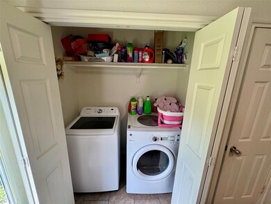 Washroom featuring washer and dryer and tile patt