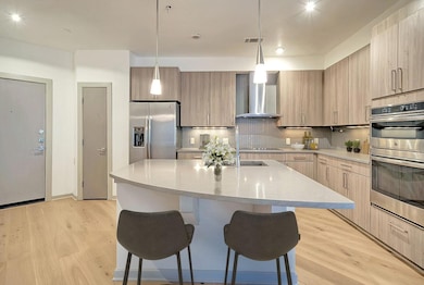 Kitchen with stainless steel appliances, wall chi
