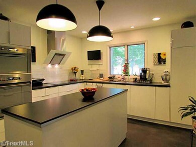 Kitchen. Large island provides convenient place for food prep - bet you can t find the dishwasher.  It s hidden behind a cabinet panel!