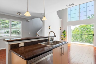 Kitchen featuring dishwasher, a sink, wood finish