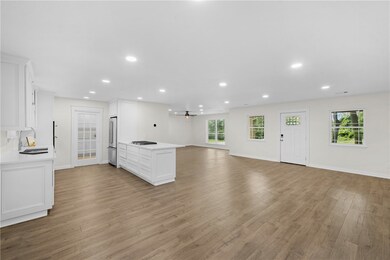 Kitchen featuring open floor plan, stainless steel