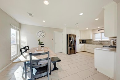 Kitchen featuring stainless steel fridge, a sink,