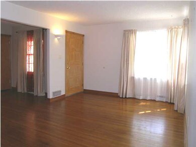 A VIEW OF THE LIVING ROOM FROM THE HALL TOWARD THE