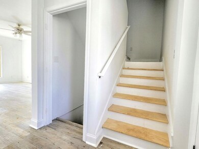 Staircase with hardwood / wood-style flooring and 