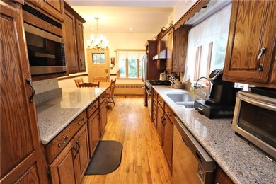 Kitchen has oak cabinets & quartz counters, built-