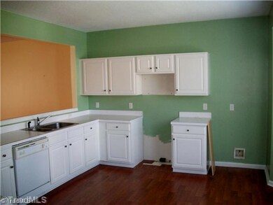 Kitchen. Kitchen overlooks great room and is complimented by bay windows!  Beautiful floors provide a wam feel.