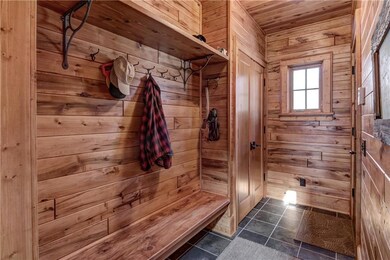 Mudroom with bench and coat closet.