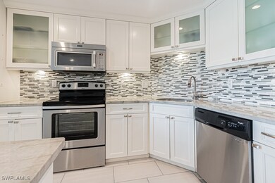 Kitchen with stainless steel appliances, a sink, l