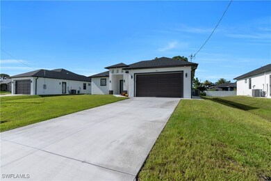 View of front of home with stucco siding, a garage