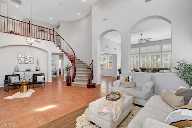 Living room featuring visible vents, arched walkwa