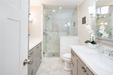 Bathroom with crown molding, vanity, recessed ligh