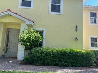 Entrance to property with stucco siding