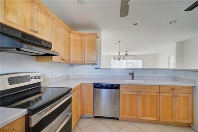 Kitchen with exhaust hood, sink, light tile patter