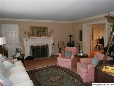 Another view of living room with wood burning fire