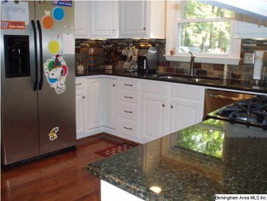This view of the kitchen shows off the granite cou