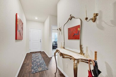 Corridor featuring baseboards and dark wood finis