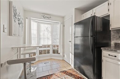 The kitchen offers a breakfast area with a large b