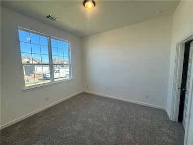 Carpeted empty room with baseboards