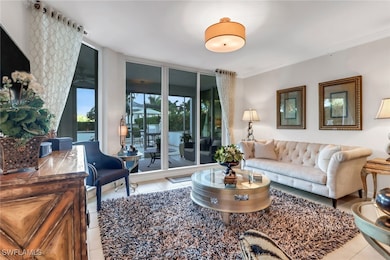 Living room featuring crown molding and light tile