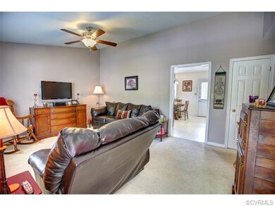 Great room also features a ceiling fan and is open