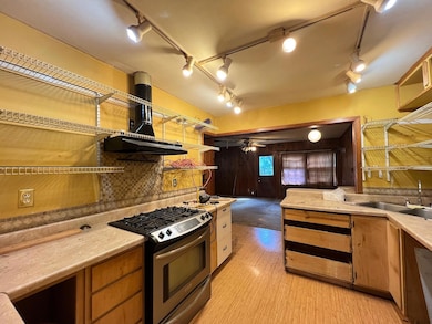 Kitchen with tasteful backsplash, sink, ventilatio