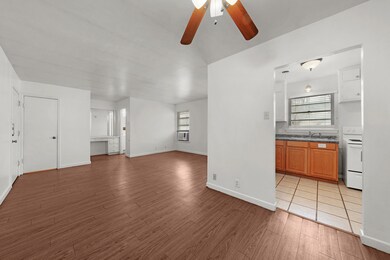 Unfurnished living room with light wood-type flooring and a ceiling fan