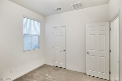 Unfurnished bedroom featuring light carpet and baseboards